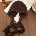 Macro view of dark brown knit earflap hat with long braided tassels and textured checkers - Knit Earflap Tassel Hat / Dark Coffee