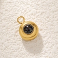 Detailed macro view of golden stainless steel round pendant with black rainbow projection stone - Gold Single Loop