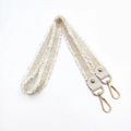 Detail of beige woven shoulder strap with gold metal hooks and bohemian fringe edges - Handheld/Underarm Style / Off White