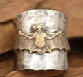 Macro shot of wide textured silver ring with embossed gold bat detail and hammered finish - US 6 / Bat Relief Style (KYRA01490)