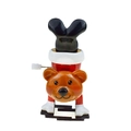 Wind-up mechanical toy featuring a brown bear performing a handstand on a white background - Upside Down Christmas Bear