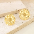 Macro shot of 18K gold floral earrings with textured petals on a stone surface - 3D Gold Flower Style (KE114947-KFC)