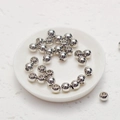 Detailed view of polished silver round spacer beads for DIY jewelry making on white ceramic - 2mm / Silver