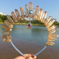 Detailed outdoor view of amber crystal crown headband with a sun pendant and water drop charm - Champagne/Sun/AB Colorful Pendant