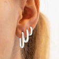 Three-piece set of silver U-shaped earrings with zircons shown on a model's ear - 5806002HB/Silver U-Shaped Minimalist Hoop Set