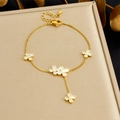 Detailed shot of gold chain bracelet with white clover charms and lobster clasp closure - White Four-leaf Flower Style (B1801)