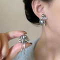 Close-up of grey pearl earrings with bow knot and rhinestone details on ear - Grey Bowknot Pearl