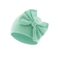 Close-up of mint green ribbed knit newborn beanie featuring a large decorative bow - Bean Green (Bow Turban Hat)