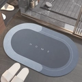 Oval grey absorbent bath mat with HOME text placed outside a modern shower area - Lake Baikal (oval) - Blue / 40*60cm