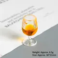 Macro view of a 38x21mm miniature wine glass charm with orange resin filling - Gold