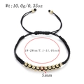 Detail of adjustable 18-28cm braided rope bracelet with 5mm gold metal beads - Gold