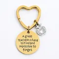 Gold heart keychain with engraved teacher quote and sparkling apple charm on white background - JSYZ007 A great TEACHER is hard to find / Gold