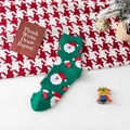 Festive Christmas green crew socks featuring Santa Claus patterns and cute holiday polka dots - One Size / Green
