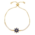 Adjustable gold bolo bracelet featuring a blue zircon daisy flower charm and white rhinestones - Blue