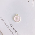 Detail of round golden letter Y pendant with pink enamel for DIY jewelry crafting - Letter Y