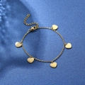 Elegant gold chain bracelet with five heart pendants on a sparkling navy background - Heart Pendant Single Layer