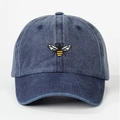 Washed denim baseball cap in navy blue featuring a detailed bee embroidery on the front - Adjustable / Navy Blue