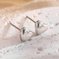 Minimalist silver heart stud earrings with polished metal finish on natural stone base - Heart Stud Earrings / Silver