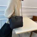Minimalist black faux leather bucket bag with adjustable strap in matte finish style - Black