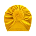 Detail of mustard yellow velvet baby beanie with a large fluffy pompom on top - One Size / Yellow