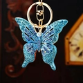 Detailed close-up of blue rhinestone-studded butterfly keychain with golden metal ring - Single Pack / Blue