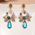 Detailed view of vintage gold earrings with blue and purple resin crystals and drop pendants - Blue Flower