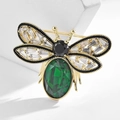 Elegant gold bee brooch featuring a large emerald green stone and sparkling crystal wings - Emerald Gemstone Bee Style