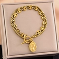 Double-layered gold chain bracelet with pig nose links and queen relief coin pendant - Bracelet