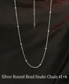 Detailed view of a silver snake chain necklace with beads on brown silk background - Style 20: Silver Round Snake Bead Chain 41+6cm