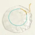 Detail of light blue beaded bracelet with gold lobster clasp and extension chain - Light Blue