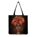 Detail of reusable black canvas tote bag with artistic African woman portrait print - Afro Lady Portrait-Warm Orange Turban