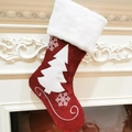 Close-up of red Christmas stocking with white tree and snowflake appliques on mantel - Christmas Tree
