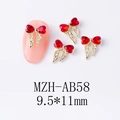 Détail de bijoux d'ongles avec nœud en cristal rouge et pompons dorés élégants - Nœud Rouge Vif (AB58)