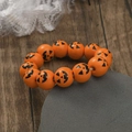 Halloween wooden bead bracelet with orange pumpkin face prints on textured background - Orange Black Pumpkin