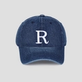Détail d'une casquette de baseball en jean vintage avec broderie 3D de la lettre R blanche - Bleu clair