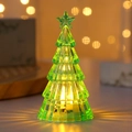 Close-up of a mini green LED Christmas tree light with warm golden glow and star topper - Green (Warm Light Small)