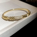 Macro shot of 18K gold plated bangle featuring zircon pavé sections and polished texture - 5# Golden Segmented Thread Style (5#)