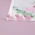 Close-up of three pink glitter resin miniature ducks for DIY landscape decoration - Pink