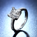 Macro shot of princess cut moissanite ring with side accent diamonds on a dark blue background - Y119 Princess Cut Pave