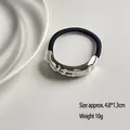 Minimalist black elastic hair tie with textured silver geometric metal piece detail - Single Wave Bar Silver