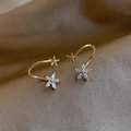 Elegant gold flower stud earrings with sparkling cubic zirconia on brown fabric texture - Small Snowflake Hoop Studs / Gold