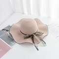 Pink straw sun hat with wavy brim and black polka dot mesh bow detail shown from above - M (56-58cm) / Pink