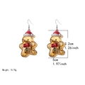 Golden resin Christmas bear earrings with red hats and white trim on white background - Gingerbread Man Earrings