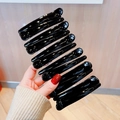 Set of 12 black glossy plastic duckbill hair clips neatly arranged on a card - 12# Large Glossy Black