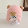 Detail of pink knitted baby hat featuring plush bear ears and Lucky embroidery - 1-3 Years / Pink