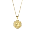 Golden hexagonal necklace with letter M pendant and beaded edge on white background - Letter M