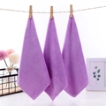 Three purple coral fleece square towels hanging on a rope with a clean home decor background - 23x23cm / Purple
