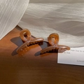 Translucent amber 4.5cm small hair claw clips on a wooden surface with soft shadows - 1 Piece / Jelly Coffee