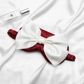 Deep red satin sleep mask featuring a large white bow and elasticated silk head strap - Burgundy