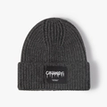 Dark grey chunky knit beanie featuring a branded rectangular woven label on the front cuff - One Size / Dark Gray